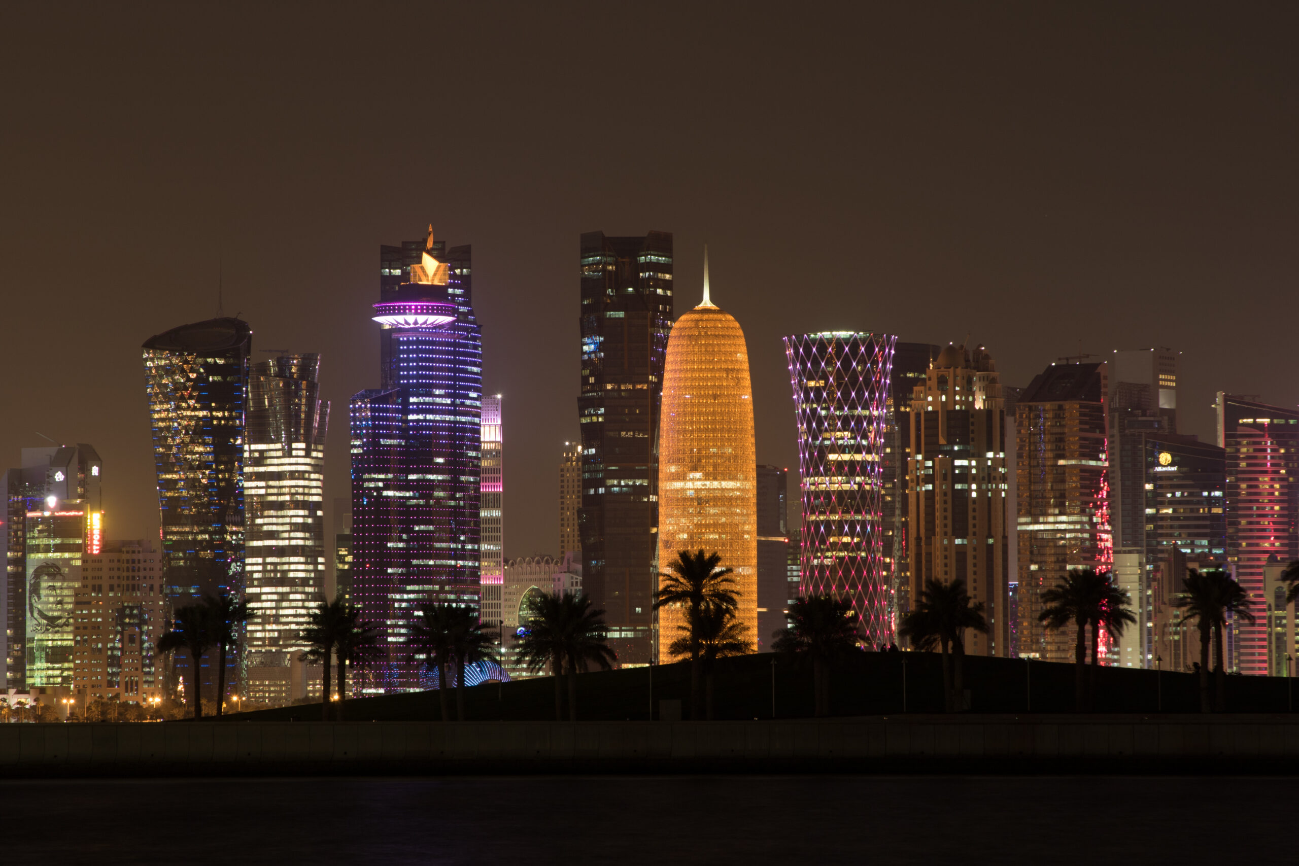 Beautiful view of illuminated skyscrapers of metropolis at night.